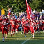 Football Team storming onto the field