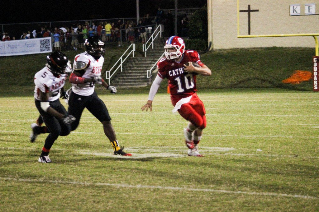 Quarter back running towards the end zone